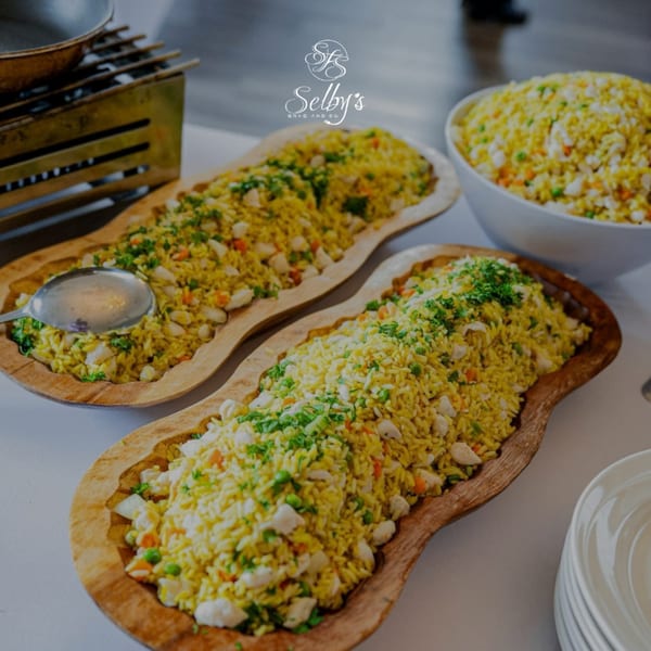 Selby's Grab and Go's chicken and rice dish, served in two wooden bowls and one white bowl.
