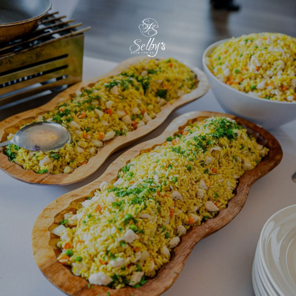 Selby's Grab and Go's chicken and rice dish, served in two wooden bowls and one white bowl.