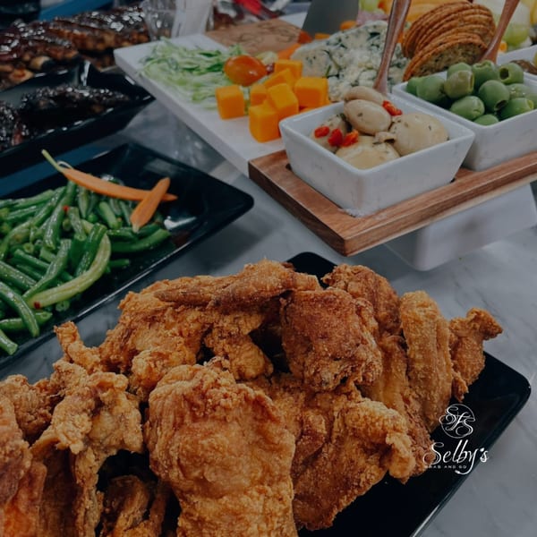 Selby's Grab and Go fried chicken, green beans, and a charcuterie board with cheese, olives, and crackers.