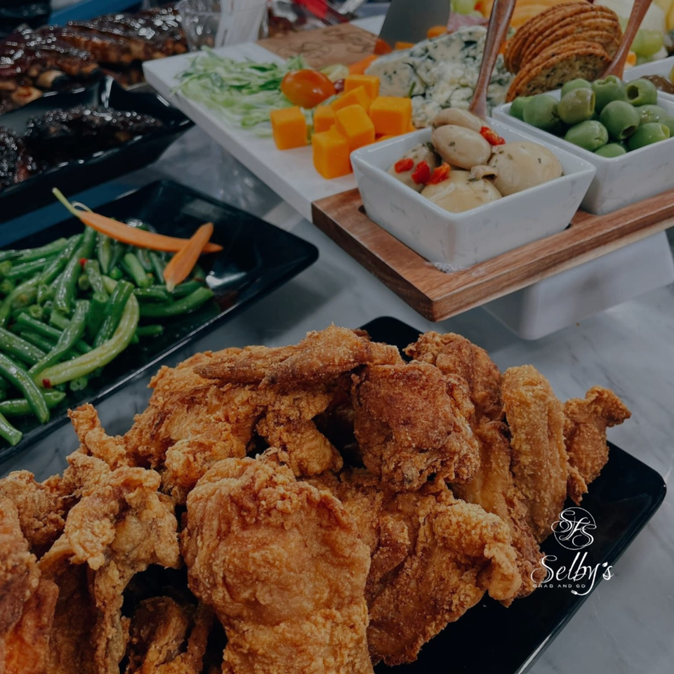 Selby's Grab and Go fried chicken, green beans, and a charcuterie board with cheese, olives, and crackers.